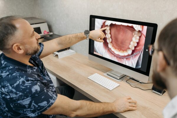 photo of a harley street dentist showing a patient their teeth