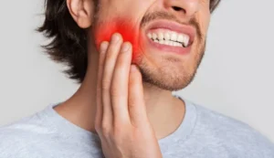 are dental implants painful? image of a man holding his painful tooth