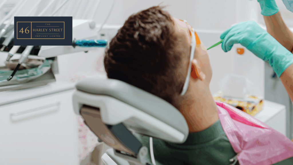Patient on a dental chair getting treatment done by a dentist. Image has been taken behind the chair looking forward.