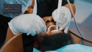 Image of dentist holding instruments in a patient's mouth
