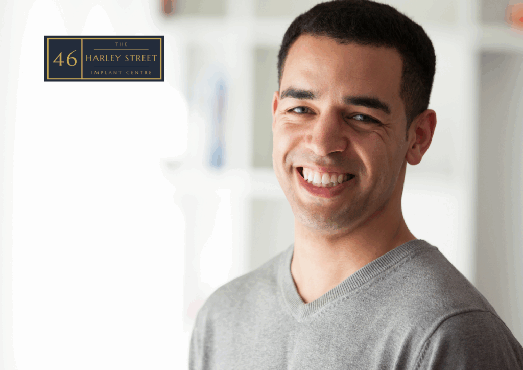 Image of a person lookingdown the camera with their head slightly titled while smiling