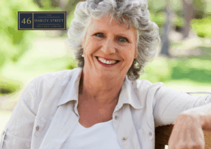 Person sitting on bench relaxed whilst smiling towards the camera