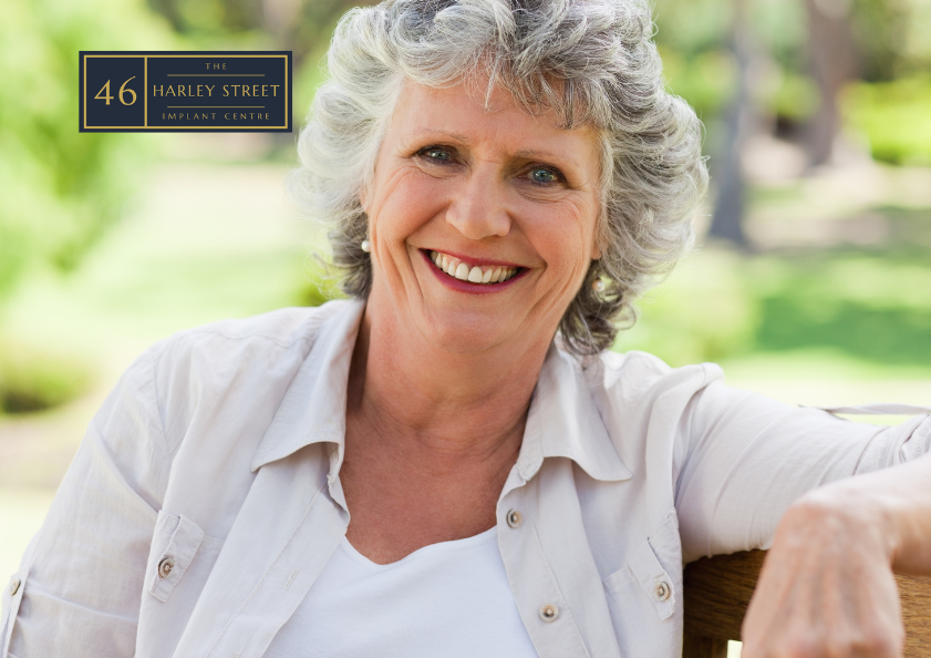 Person sitting on bench relaxed whilst smiling towards the camera