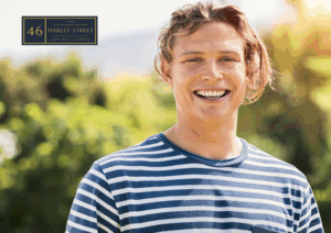 Person smiling in a green area looking directly at the camera.