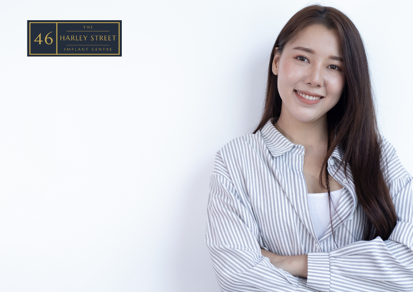 image of person leaning against white wall while smiling